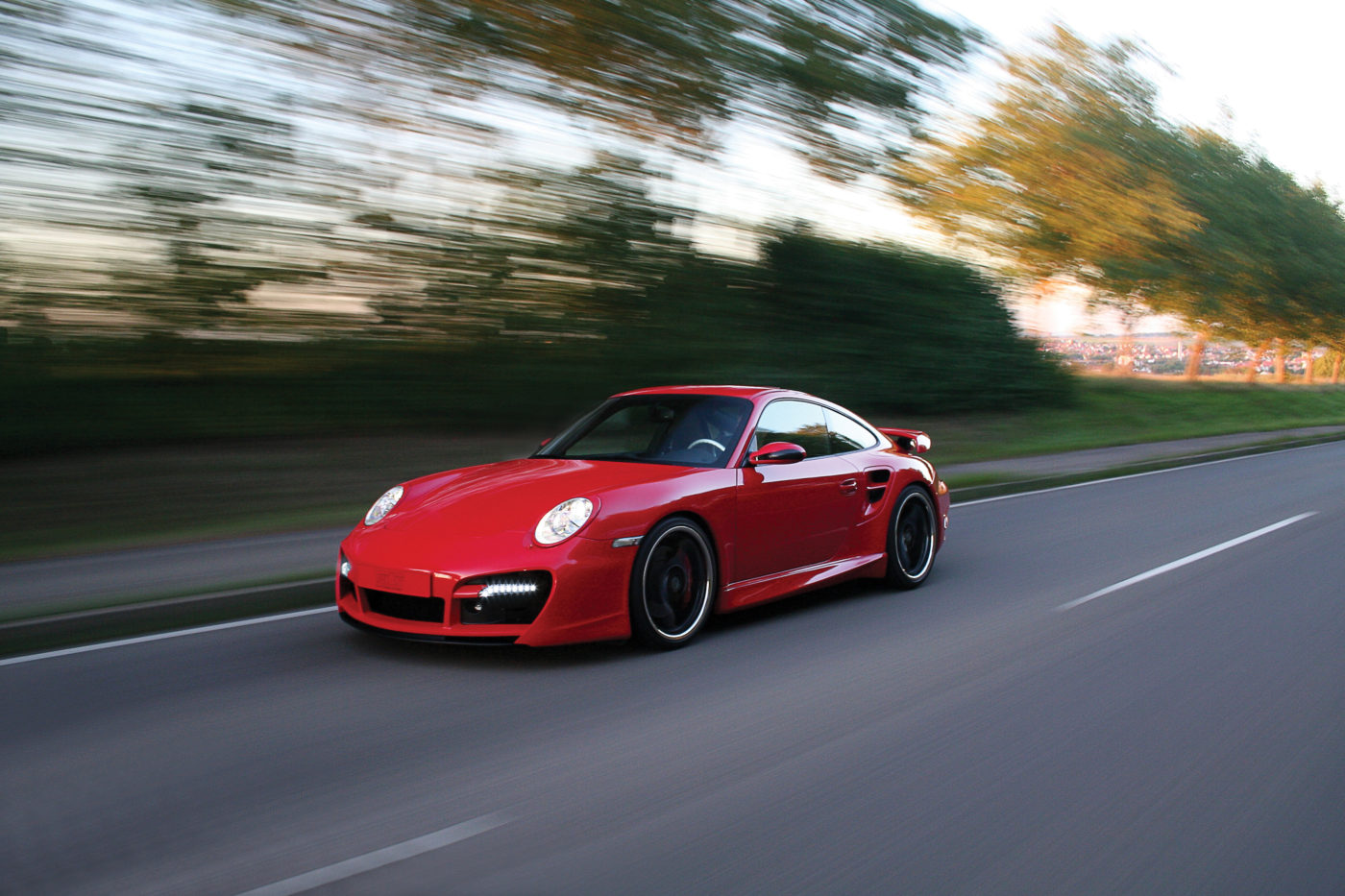 Porsche 911 Turbo Techart Tuning in red on road.